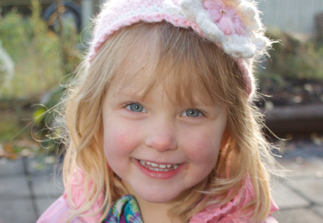 smiling young girl with a knitted hat