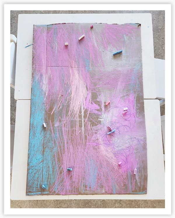 Photo 13: A Children's process art piece, using pale pink and blue hues inspired by the transgender flag