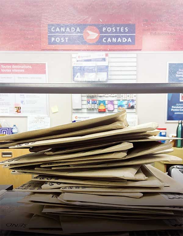 Photo 15: A pile of packages on the counter of a post office ready to send out